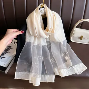 Detailed view of women's silk-blend organza pearl beaded sunscreen long fashion shawl scarf.