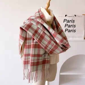Retro plaid tassel scarf detail view, cozy winter thick warm shawl draped on mannequin.
