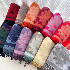 Detailed view of colorful jacquard floral scarves with fringe, warm core-spun yarn material.