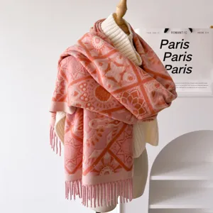 Close-up of pink and orange patterned winter knit scarf with cozy tassels and texture.