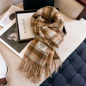 Brown plaid fringed scarf detail shot, cozy autumn winter classic design accessory for women.