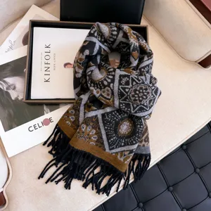 Close-up detail of a thick warm retro geometric patterned winter scarf with soft black tassels.