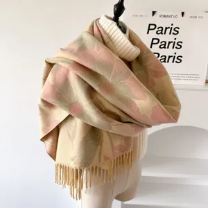 Detailed view of the floral patterned cashmere-feel winter scarf with delicate fringe edges.