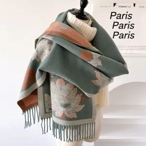 Detail view of green floral jacquard tassel scarf draped on mannequin showing texture.
