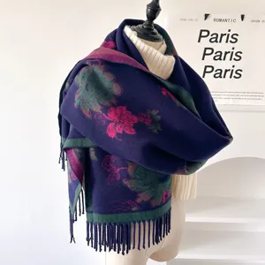 Detailed view of women's thick jacquard knit winter scarf shawl with floral pattern and fringe.