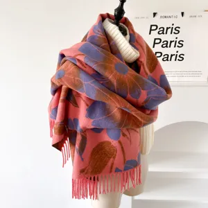 Close-up detail of the floral pattern and fringe on the warm autumn winter scarf shawl.