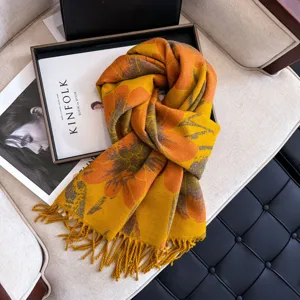 Detailed close-up of the stylish autumn and winter floral patterned soft tassel scarf.