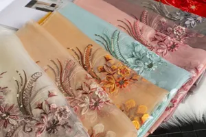 Detailed view of luxury silk scarves featuring exquisite 3D floral embroidery and sparkling sequins.