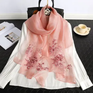 Pink silk embroidered scarf featuring delicate floral patterns, elegant and stylish accessory for women.