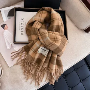 Detailed view of winter camel plaid tassel scarf, cozy and stylish warm shawl for women.