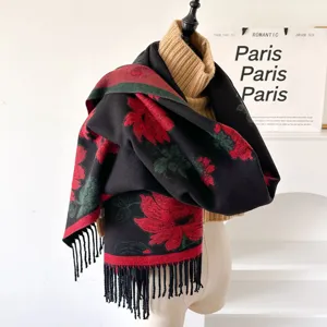 Close-up detail of the cozy winter jacquard scarf with red floral pattern and fringe.