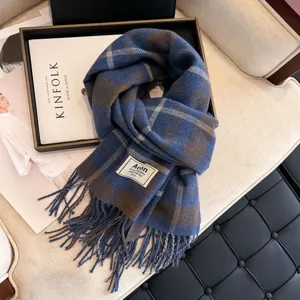 Blue and brown plaid winter scarf with fringe detail, cozy woven tassel shawl for women.