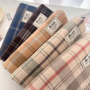 Close-up detail view of colorful plaid fringe scarves showcasing soft winter texture and design.