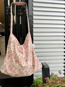 Close-up detail of vintage floral cotton shoulder bag with cute pattern and side label view.