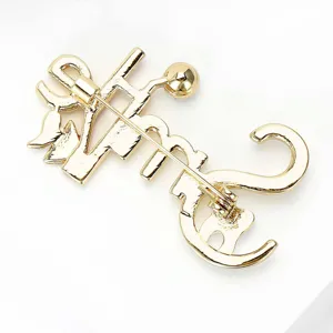 Gold-toned metal letter brooch back view, stylish alloy lapel pin accessory for apparel.