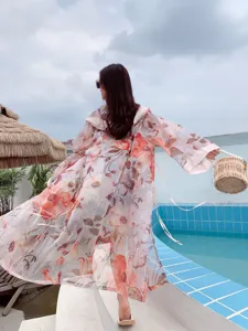 Floral print beach cover-up cardigan, lightweight long sleeve sun protection wear detail.