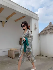 Tropical leaf print summer beach cover-up detail, lightweight long sleeve cardigan style.