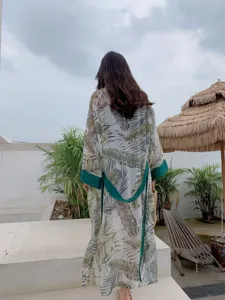 Tropical leaf print long beach kimono cover up with green cuffs and waist belt for summer.
