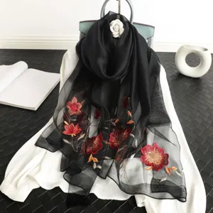 Black sheer floral embroidered scarf detail showing exquisite sequin flower craft and soft fabric.