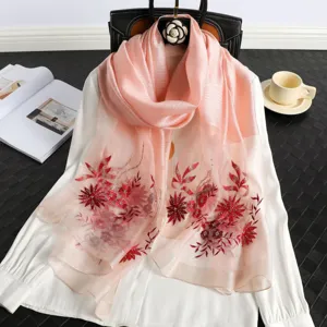 Elegant pink silk scarf with delicate red floral embroidery, perfect for spring and autumn.