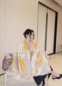 Close-up detail of women's autumn winter imitation cashmere printed scarf shawl with cute cats.