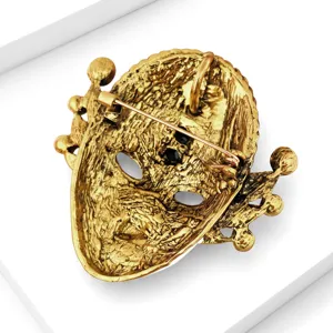 Spilla a maschera facciale dorata vintage con strass neri scintillanti, elegante accessorio moda.