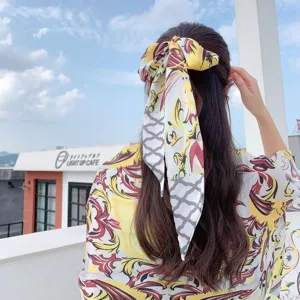 Exquisite vintage printed hair scarf detail with delicate baroque patterns and light fabric.