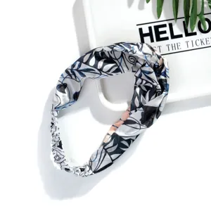 Close-up detail of the silk-like twisted headband with elegant black and blue leaf print.