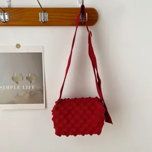 Red bubble knit crossbody bag with wide strap, casual shoulder bag for daily commute and travel.