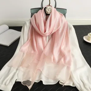 Elegant pink silk wool scarf for women, featuring a shimmering gold grid pattern. Perfect chic shawl.