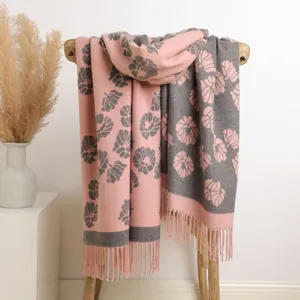 Detailed close-up view of women pink grey floral knit winter warm scarf tassel shawl.