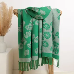 Green floral core-spun yarn scarf detail showing exquisite double-sided pattern and tassel hem.