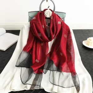 Detailed view of women's silk wool scarf, red and black grid embroidery fashion shawl.