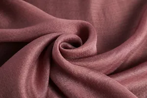 Mulberry silk fabric detail close up showing soft texture and elegant mauve color.