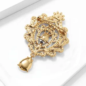 Vintage gouden filigraan broche met elegante druppelhanger voor damesmode accessoires.