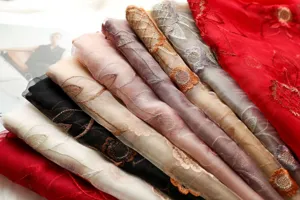 Luxury mulberry silk wool embroidered scarf shawl detail showcasing floral craft and soft fabric.