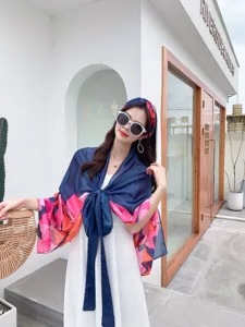 Detailed view of the stylish floral print scarf and beach cover-up set with elegant design.