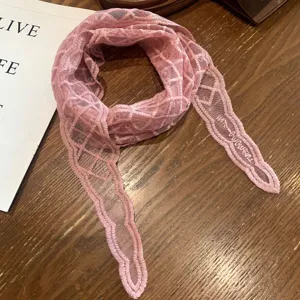 Close-up detail of the pink mesh lace scarf, lightweight jacquard summer accessory for women.