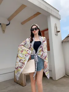 Detail view of summer printed sun protection cape and scarf set, stylish beach cover-up.