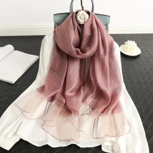 Detail view of a luxury striped silk wool shawl scarf in elegant pink, perfect for women's fashion.