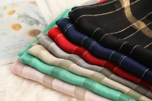Detailed view of multi-color wool blended scarves with shimmering gold stripes for autumn.