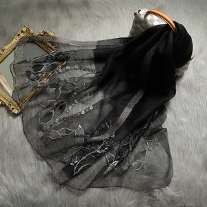Detailed view of luxury black mulberry silk long scarf featuring delicate metallic embroidery.