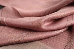 Detailed view of pink silk wool scarf fabric featuring elegant gold thread stripe patterns.