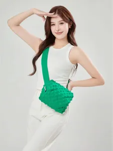 Green knitted crossbody bag for women, stylish bubble texture shoulder bag with wide strap.