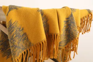 Close-up detail of the yellow and grey feather patterned warm winter tassel scarf and shawl.