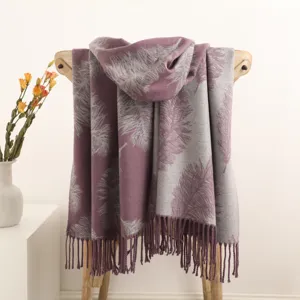 Double-sided feather pattern tassel scarf draped gracefully on a wooden chair display.