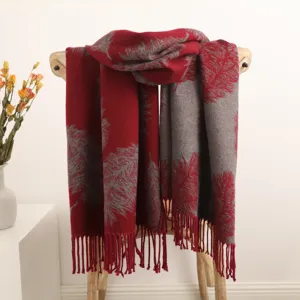 Detailed view of the red and grey reversible feather pattern tassel winter warm scarf.
