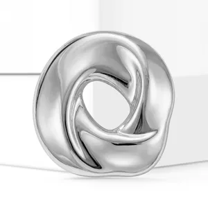 Stainless steel abstract ring brooch detail, shiny silver finish clothing accessory.