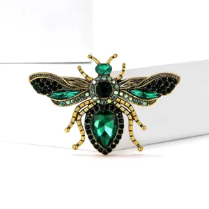 Detail shot of vintage gold rhinestone bee brooch, crystal details, elegant insect jewelry.