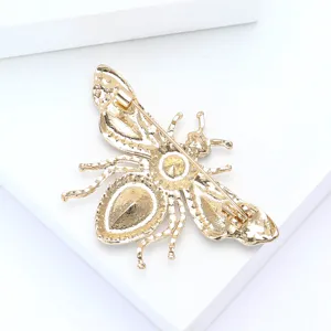 Detailed back view of a gold-plated rhinestone bee brooch, showing the secure pin clasp.